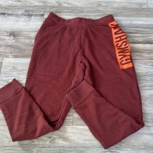 Men’s Gymshark Burgandy with Orange Logo Down Side Joggers Size Small